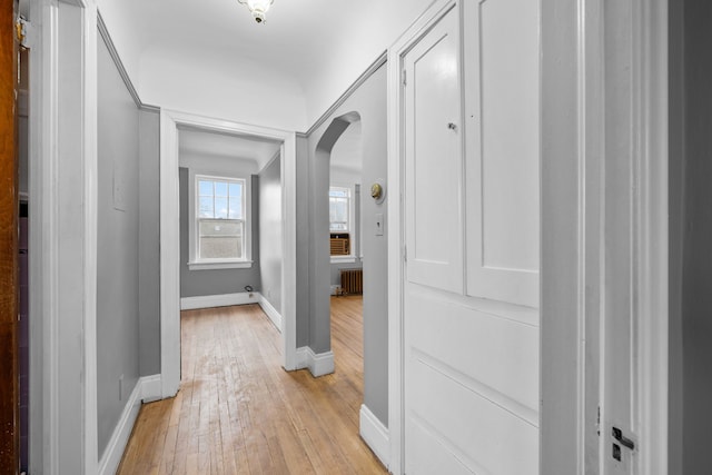 2412 Cornell St, Dearborn, MI 48124 - hall with arched walkways, radiator heating unit, light wood-style flooring, and baseboards