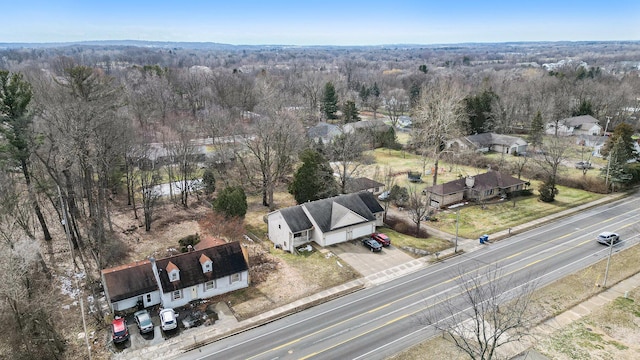 birds eye view of property with a wooded view