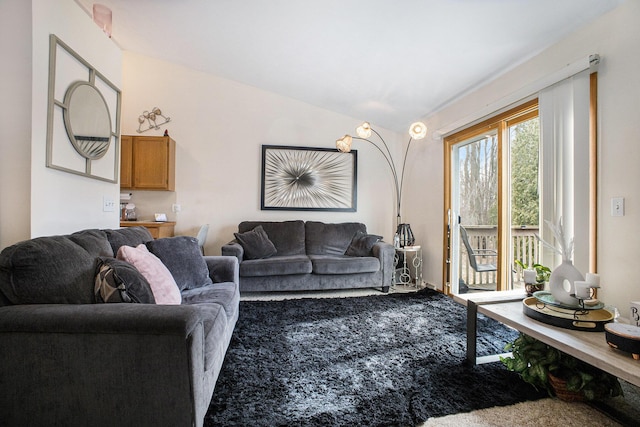 living area with carpet and vaulted ceiling