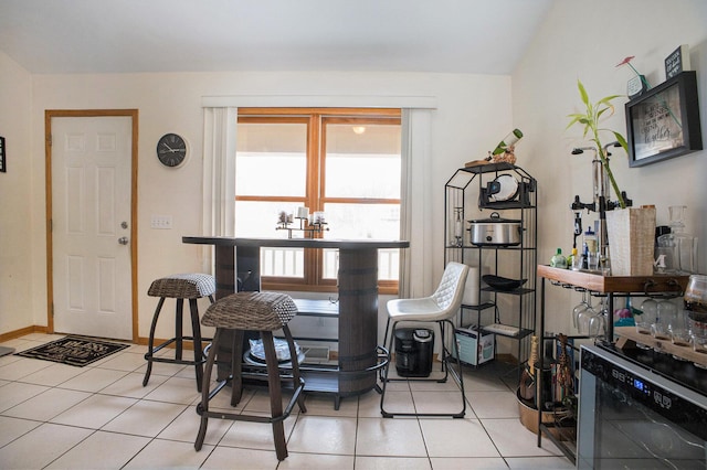 dining space featuring light tile patterned floors and baseboards