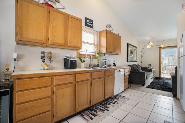 kitchen with plenty of natural light, light countertops, white dishwasher, and a sink