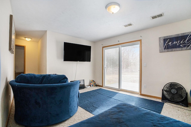 carpeted living area with baseboards and visible vents