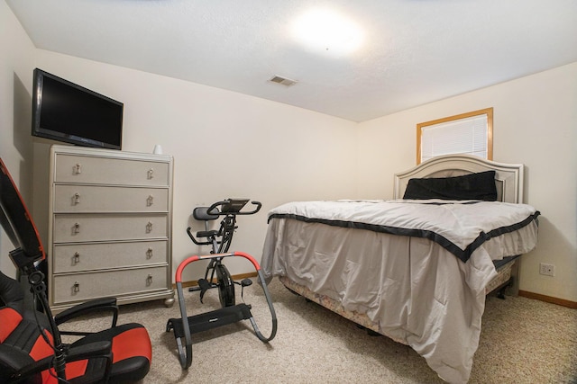 bedroom with carpet floors, visible vents, and baseboards