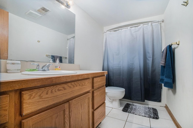 bathroom with visible vents, vanity, toilet, and tile patterned floors