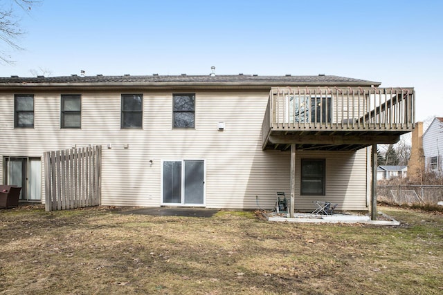 back of house with a yard, fence, and a wooden deck