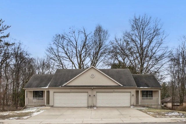 view of front of home featuring a garage, a porch, and concrete driveway