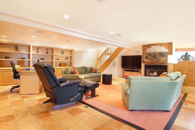 living room featuring stairs, a fireplace, visible vents, and recessed lighting