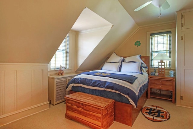 bedroom with light carpet, ceiling fan, multiple windows, and vaulted ceiling