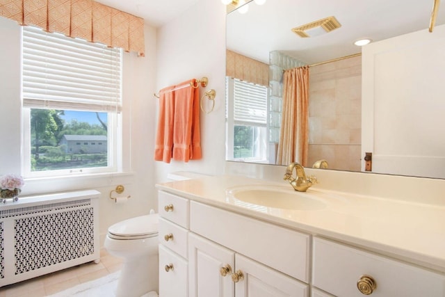 bathroom featuring toilet, a healthy amount of sunlight, visible vents, and radiator