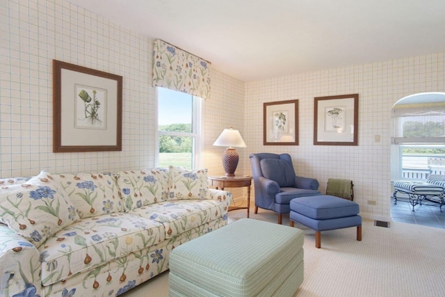 carpeted living area featuring visible vents