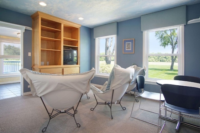 interior space with baseboards, a textured ceiling, recessed lighting, and tile patterned floors