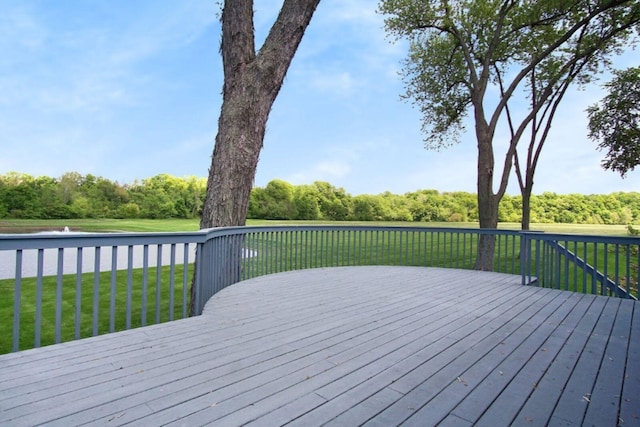 deck with a water view and a lawn