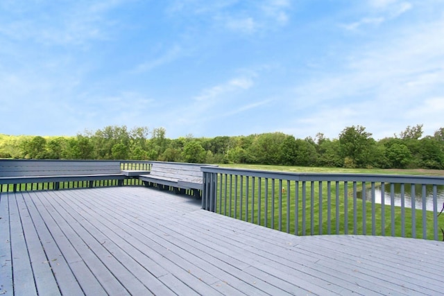 deck with a yard and a water view