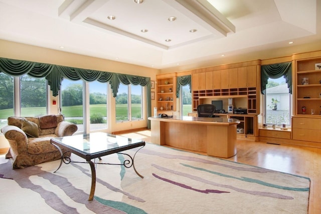 home office with light wood-style flooring, a raised ceiling, and recessed lighting