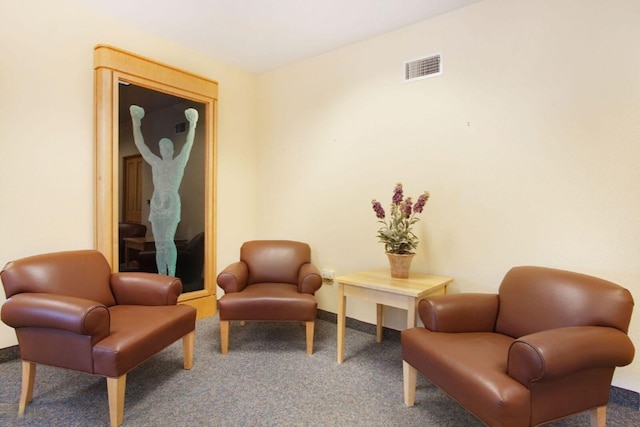 living area with carpet, visible vents, and baseboards