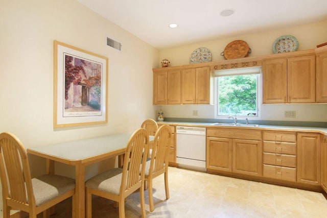 kitchen featuring white dishwasher, recessed lighting, a sink, visible vents, and light countertops