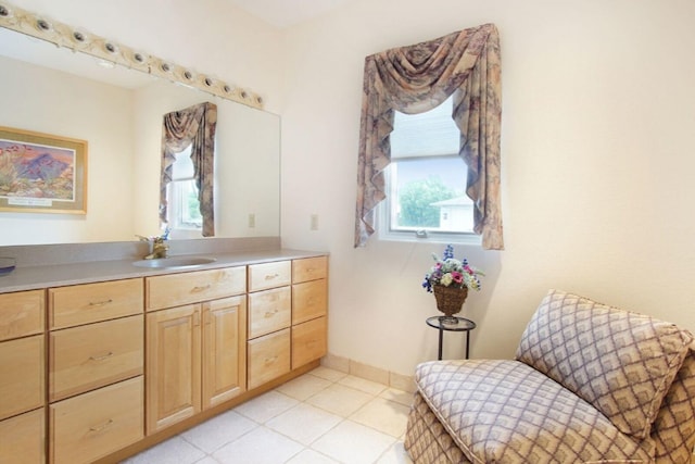 bathroom featuring tile patterned floors, baseboards, and vanity