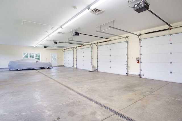 garage with visible vents and a garage door opener