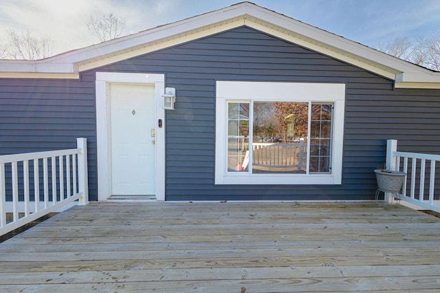 view of exterior entry with a deck