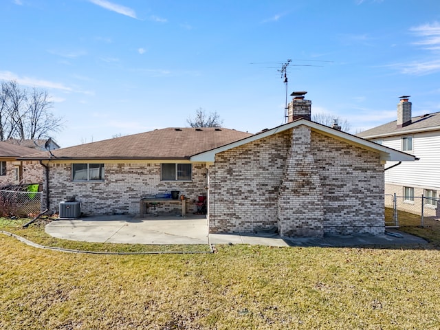 rear view of property with a yard, a patio, and fence