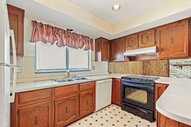 kitchen with under cabinet range hood, white appliances, a sink, and light countertops