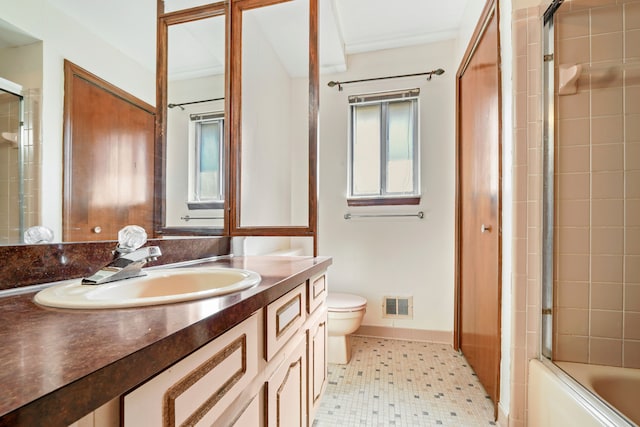 full bath featuring enclosed tub / shower combo, toilet, vanity, visible vents, and baseboards