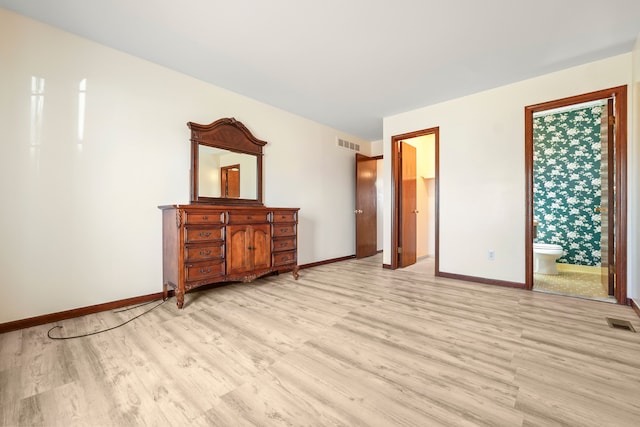 unfurnished bedroom with light wood-type flooring, visible vents, and baseboards