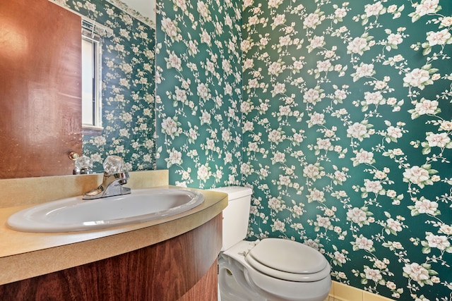 bathroom featuring toilet and vanity