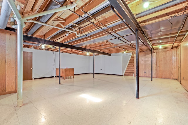 unfinished below grade area featuring stairs and tile patterned floors