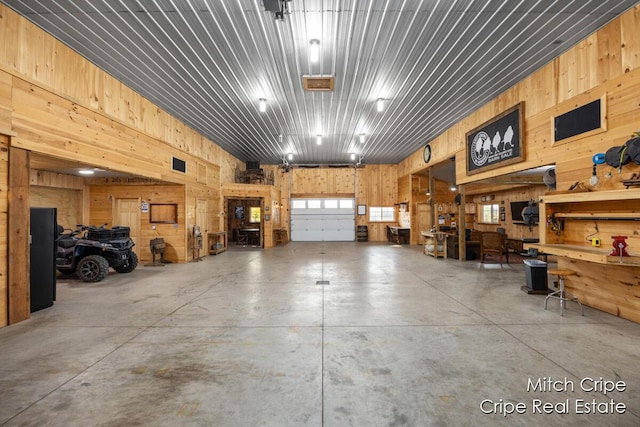 garage featuring wood walls