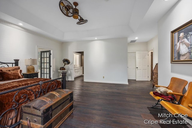 bedroom featuring baseboards, visible vents, a raised ceiling, wood finished floors, and recessed lighting