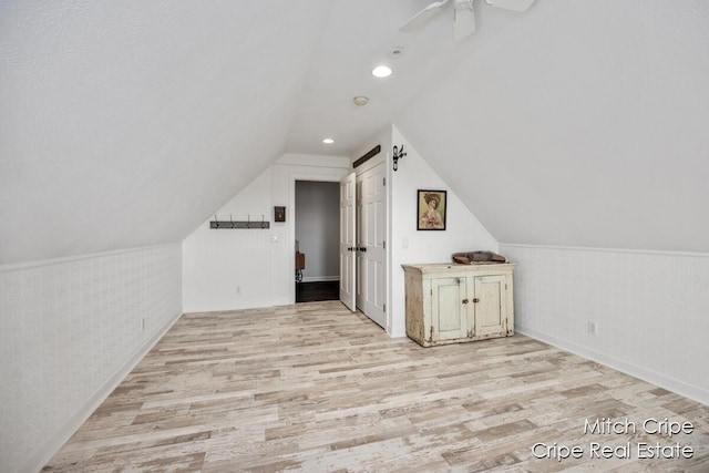 additional living space with a ceiling fan, light wood-type flooring, vaulted ceiling, and recessed lighting