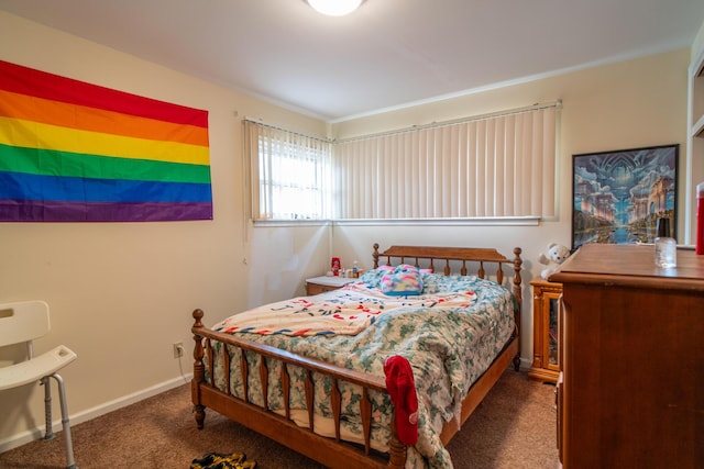 carpeted bedroom featuring baseboards