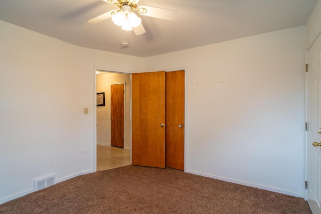 unfurnished bedroom with baseboards, visible vents, ceiling fan, carpet flooring, and a closet