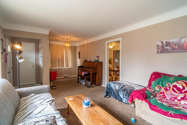 carpeted living room with a ceiling fan, visible vents, and baseboards