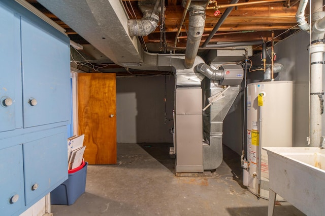 unfinished below grade area featuring gas water heater, a sink, and heating unit