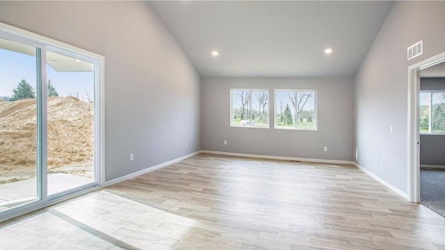 unfurnished room with lofted ceiling, recessed lighting, visible vents, light wood-type flooring, and baseboards