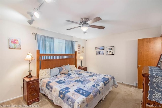 bedroom with light carpet, baseboards, a ceiling fan, and track lighting