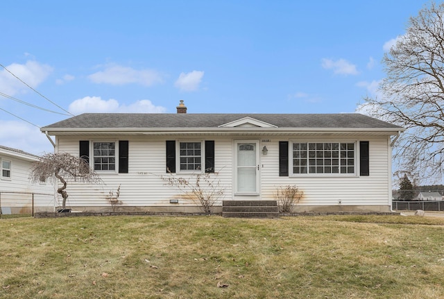 view of front of home featuring entry steps, a chimney, and a front yard