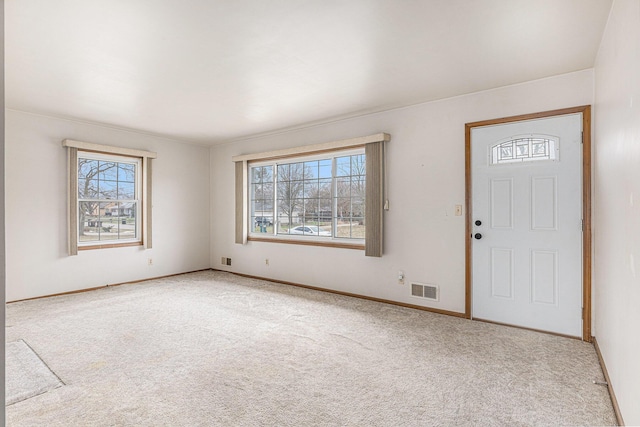 entryway featuring baseboards, visible vents, and carpet flooring