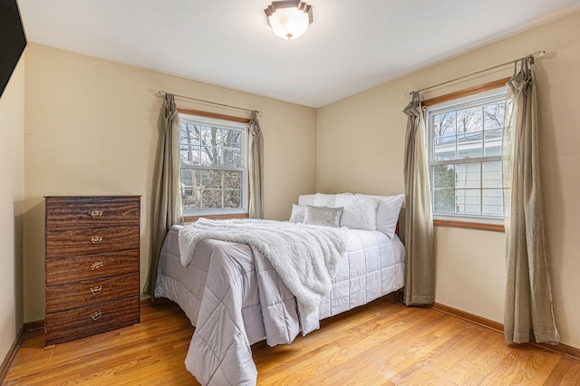 bedroom featuring light wood-style flooring and baseboards