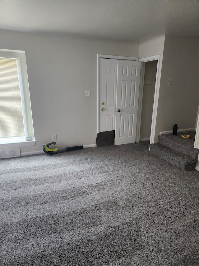 carpeted spare room with baseboards