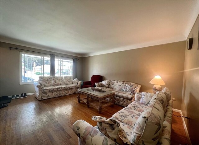 living area with wood finished floors and baseboards