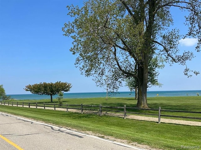 view of street featuring a water view and a rural view