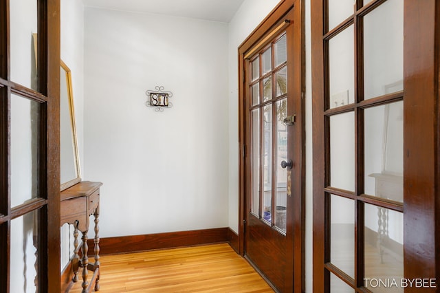 entryway featuring light wood-style flooring and baseboards