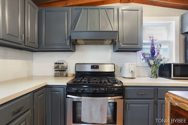 kitchen featuring stainless steel appliances, gray cabinets, premium range hood, and tasteful backsplash