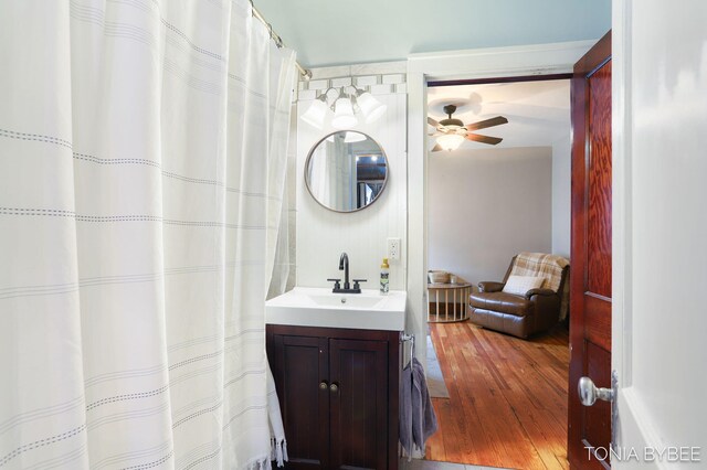 full bath featuring a ceiling fan, wood finished floors, and vanity