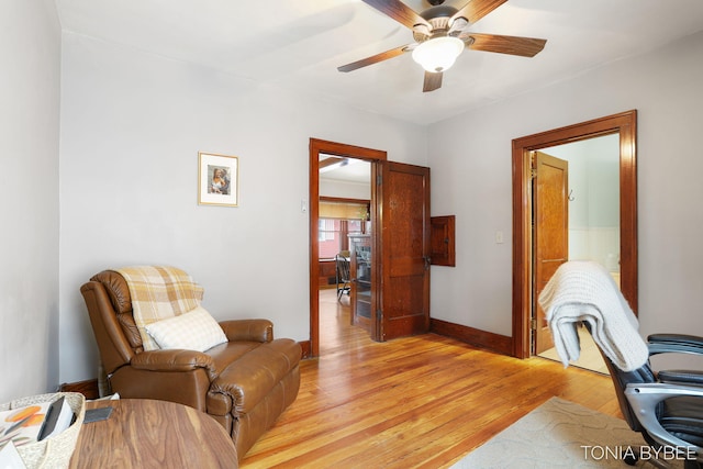 office with light wood finished floors, ceiling fan, and baseboards