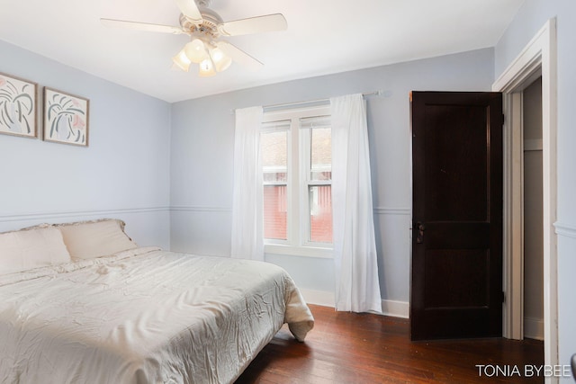 bedroom with a ceiling fan, baseboards, and hardwood / wood-style floors