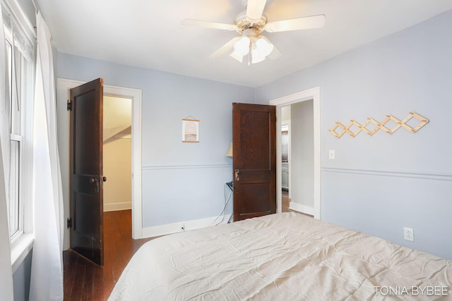 bedroom featuring ceiling fan, wood finished floors, and baseboards